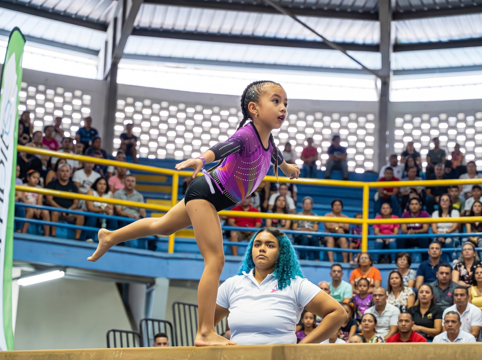 Gimnasta en viga de equilibrio ante el público